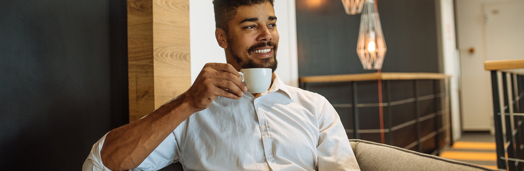 Young man drinking a cup of coffee at home
