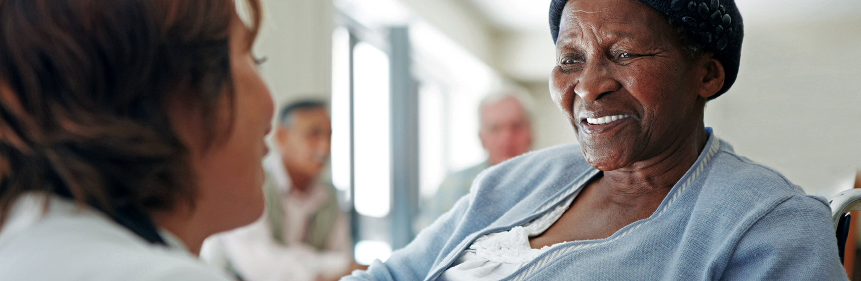 Elderly woman and nurse in long term care home