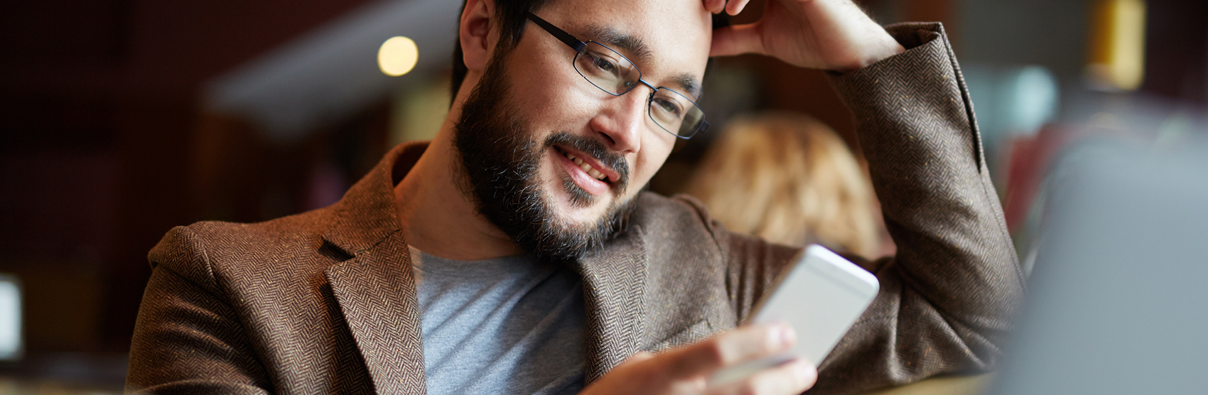 Man with beard looking at mobile device