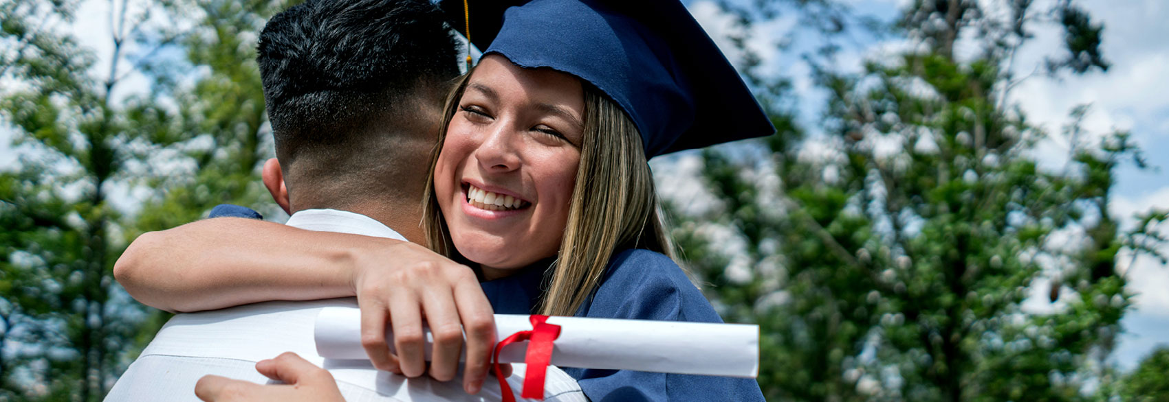 Graduation with woman hugging a man